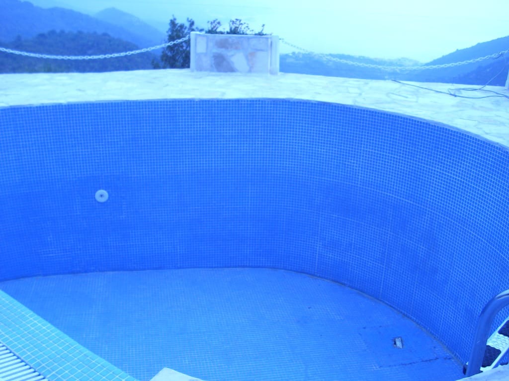 Outdoor pool with blue mosaic at a villa in Markovichi, Montenegro, with panoramic mountain and sea views.