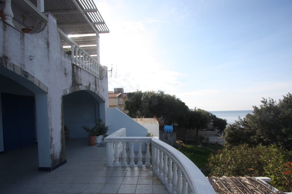 Spacious terrace with a balustrade and sea view in a house in Utjeha, Montenegro. Open area with a canopy.