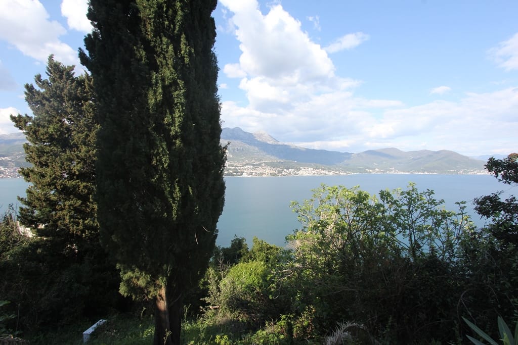 Panoramic view of the Bay of Kotor and mountains from a plot of land in Njivice, Igalo, Montenegro.