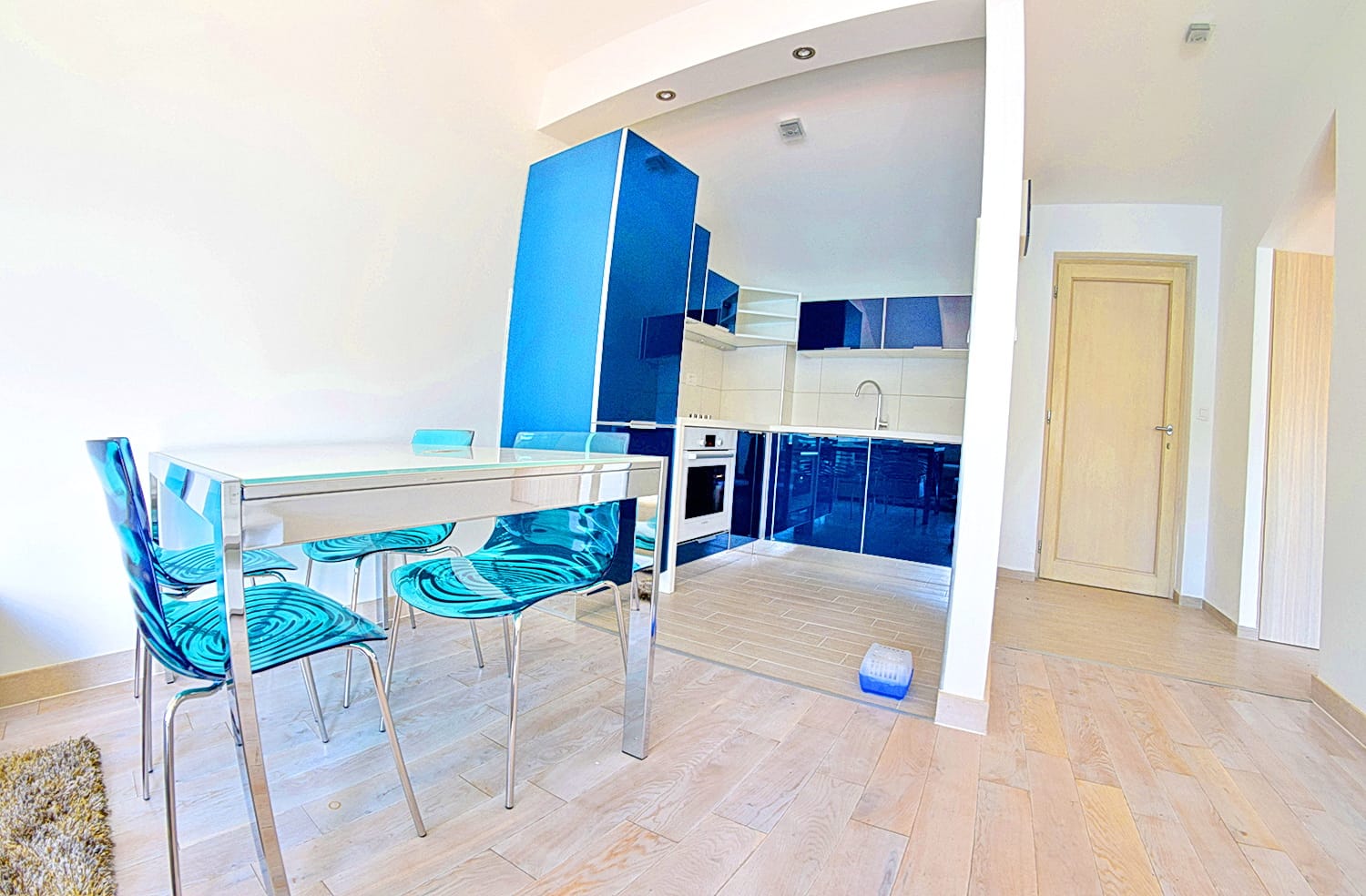 Modern kitchen with a blue fitted kitchen set and dining area in an apartment, residential complex in Morinj, Montenegro.