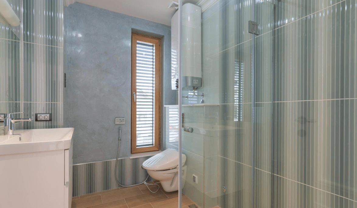 Modern bathroom with a shower cabin and window in a villa in Bijela, Montenegro: stylish finishes and fixtures.
