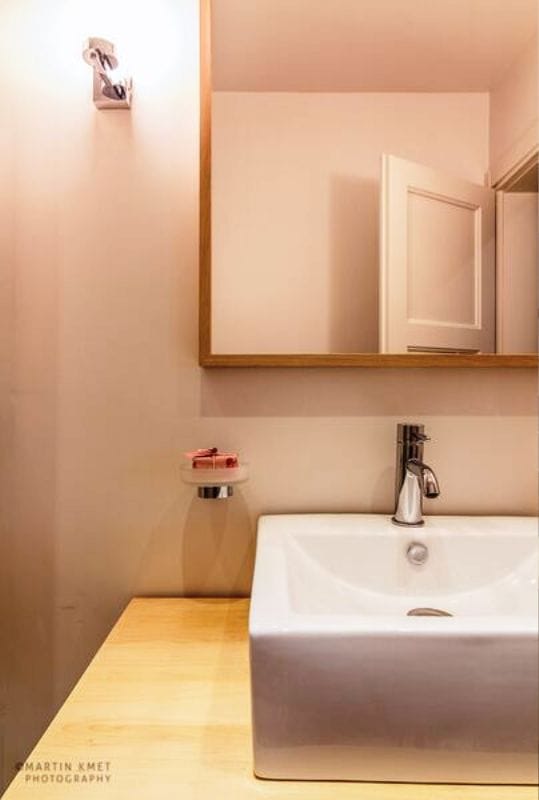 Modern bathroom with a vessel sink and wooden countertop in an apartment, Kavač, Montenegro.