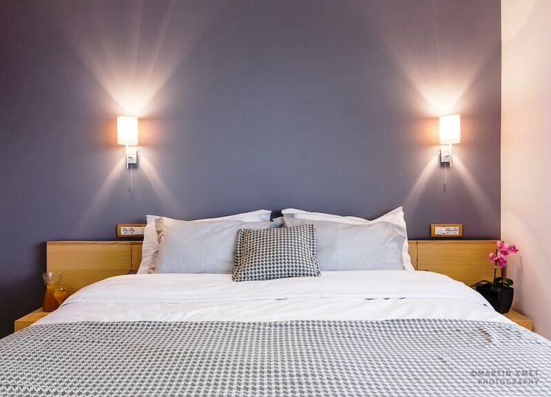 Modern bedroom with a double bed and gray walls in an apartment in Kavac, Montenegro.