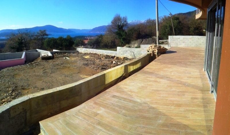 Spacious terrace with sea and mountain views in an apartment, Kavac, Montenegro. Floor finished with wood-look porcelain stoneware.