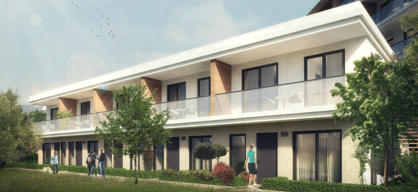 Modern residential complex in Kavac, Montenegro: a two-story building with terraces, panoramic windows, and landscaping.
