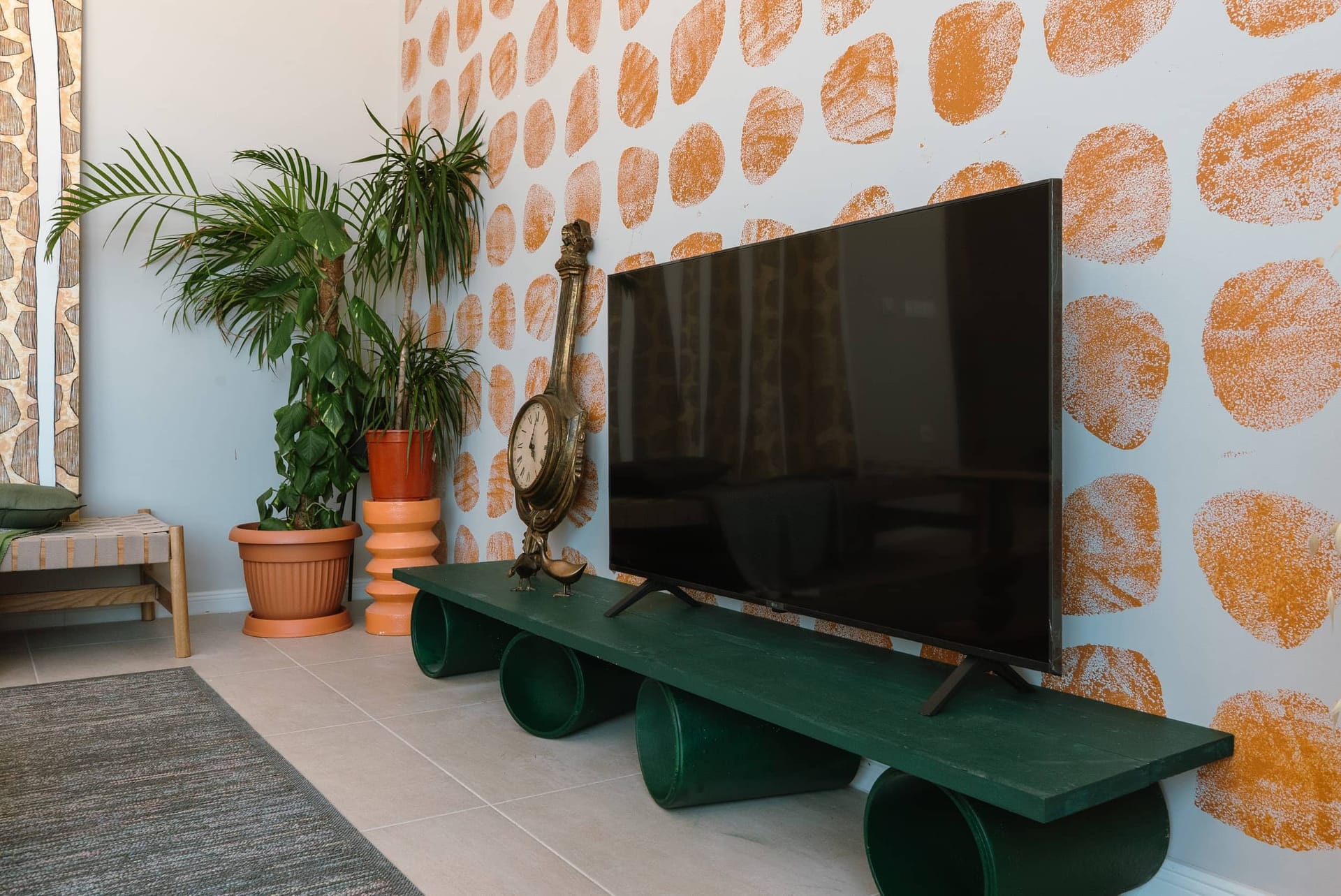 Villa living room in Krašići, Montenegro: TV area with a designer cabinet, houseplants, and an accent wall.
