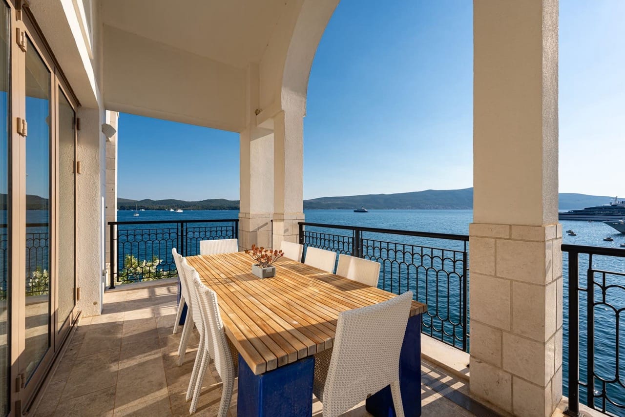 Terrace with a dining area and panoramic sea view in an apartment in Porto Montenegro, Tivat, Montenegro.