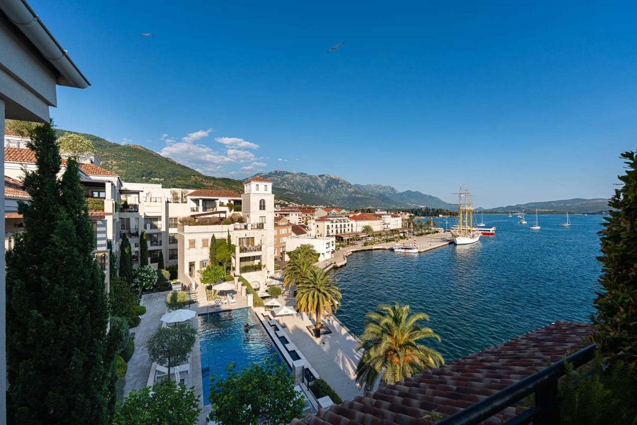 View of the pool, promenade, and yachts in Porto Montenegro, Tivat, Montenegro. Luxury residential complex by the sea.