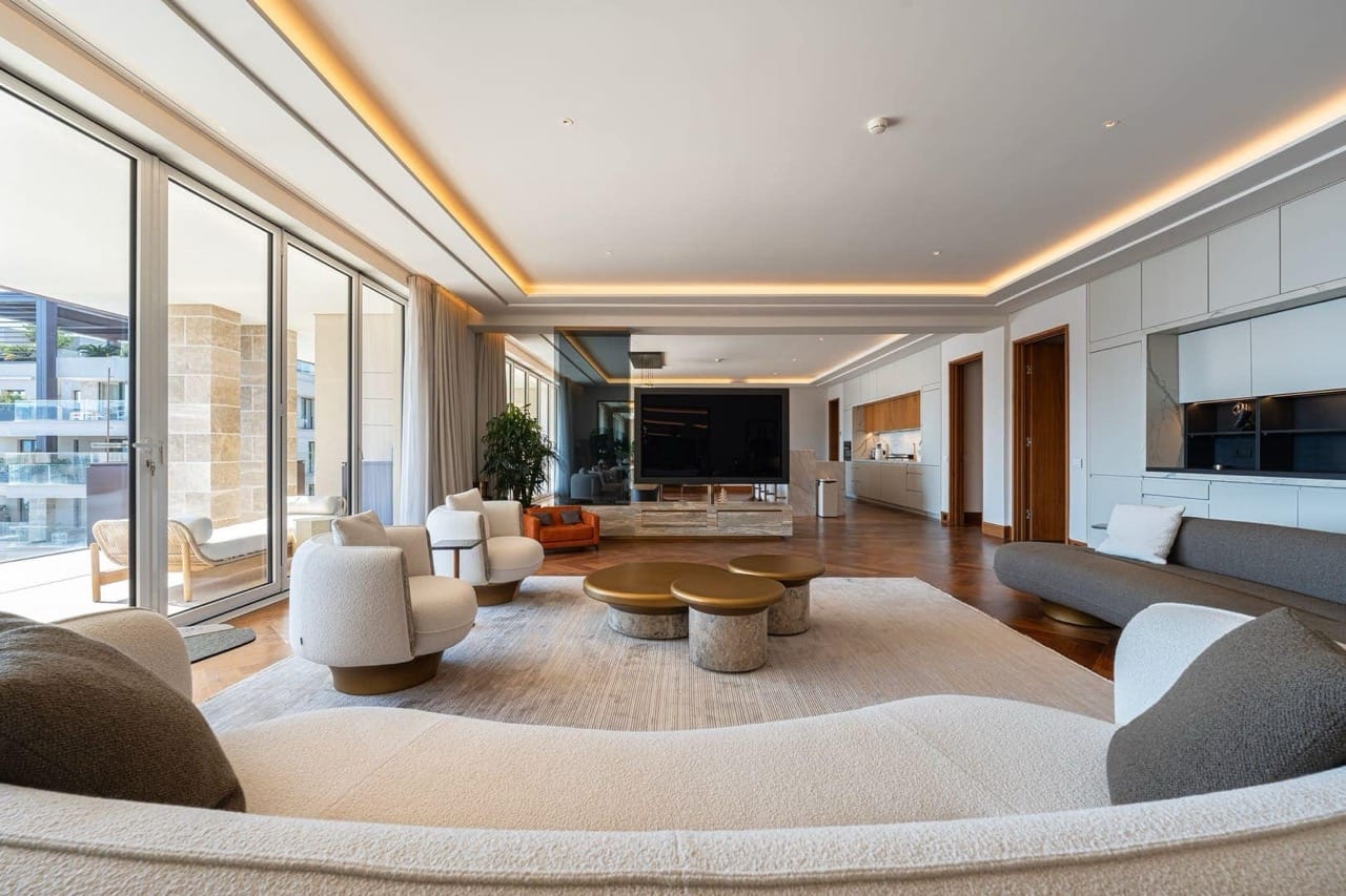 Modern living room in an apartment in Porto Montenegro, Tivat, Montenegro: designer furniture, panoramic windows, and a terrace.