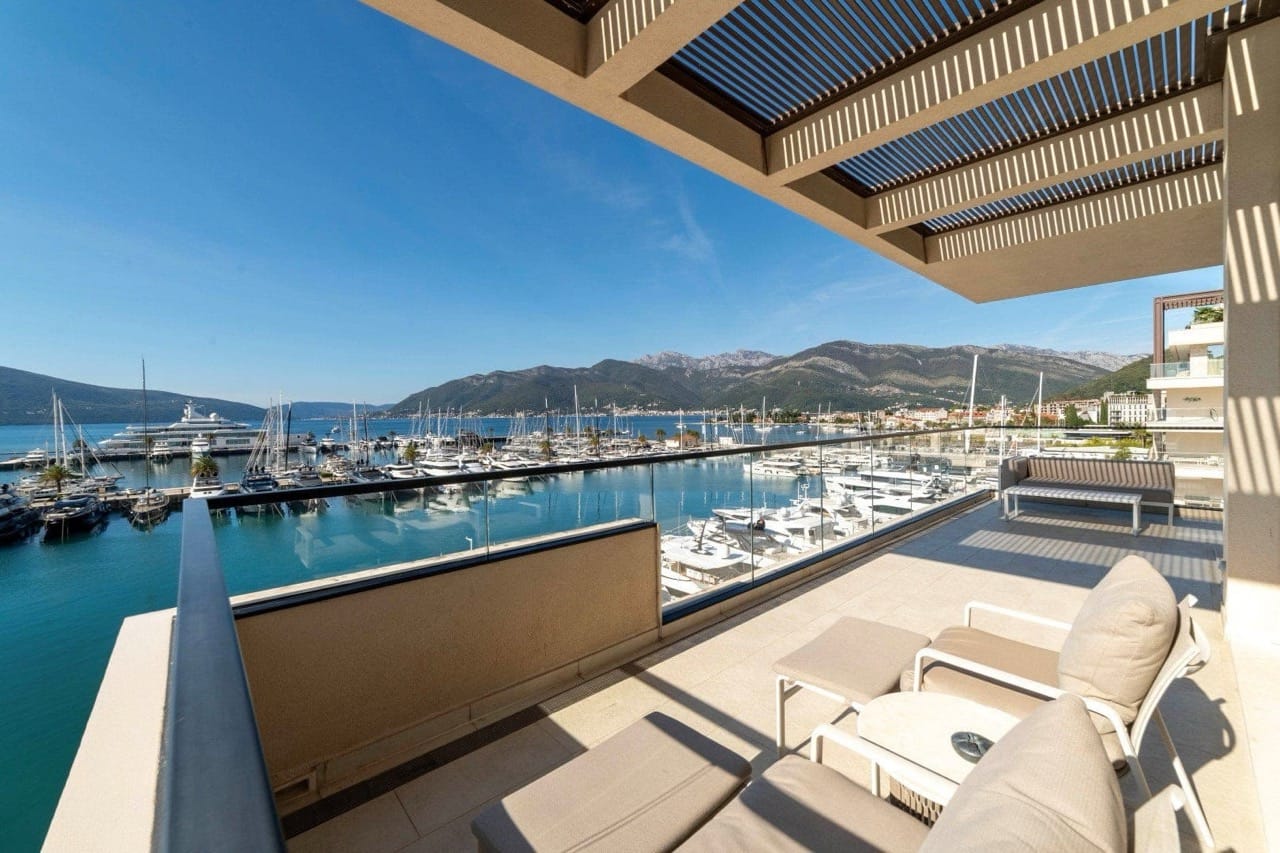 Apartment terrace in Porto Montenegro, Tivat: marina view with yachts, modern furniture and canopy, Montenegro.