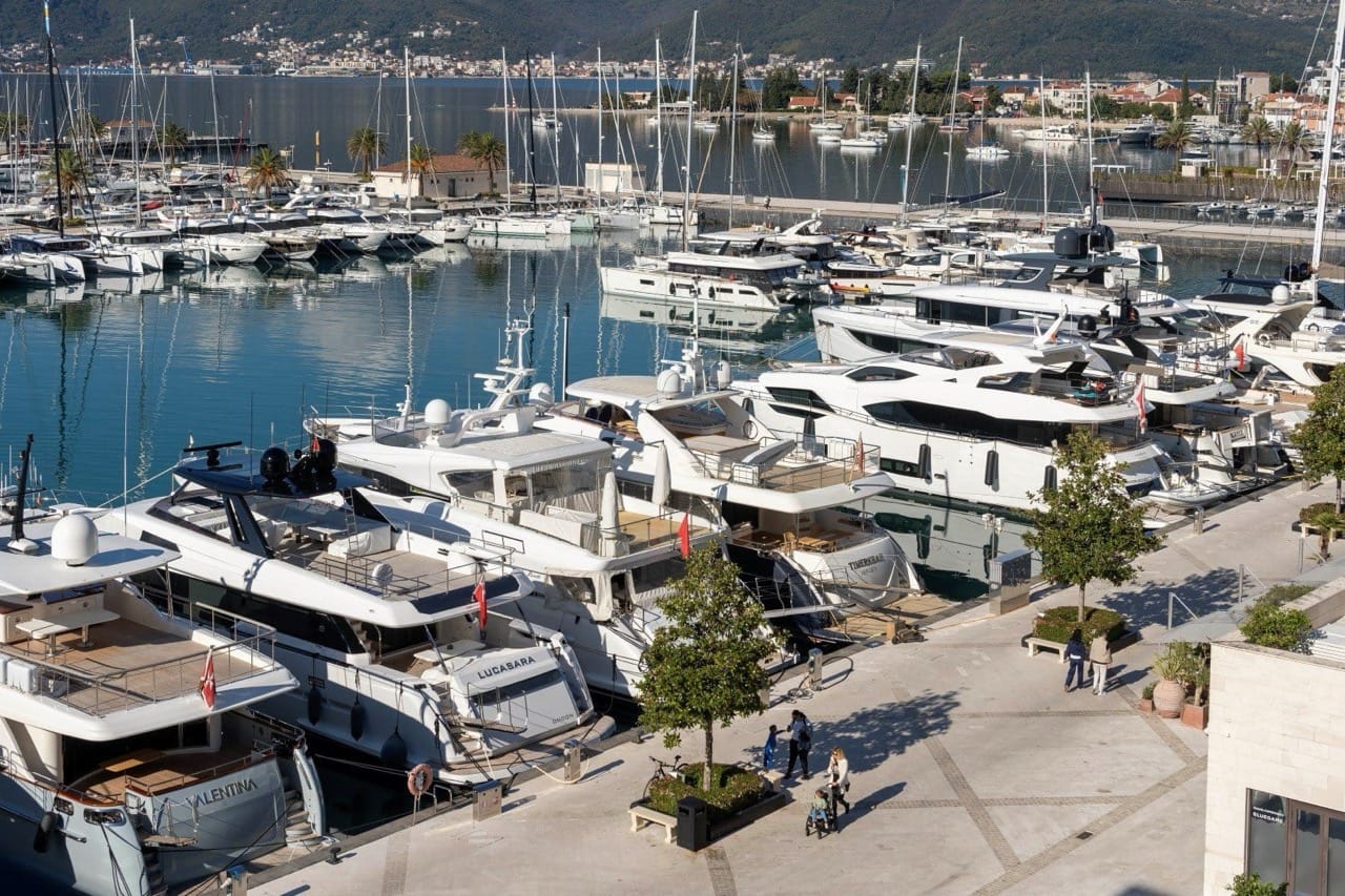 View of the luxury marina with yachts in Porto Montenegro, Tivat, Montenegro: the waterfront promenade and dock for luxury vessels.