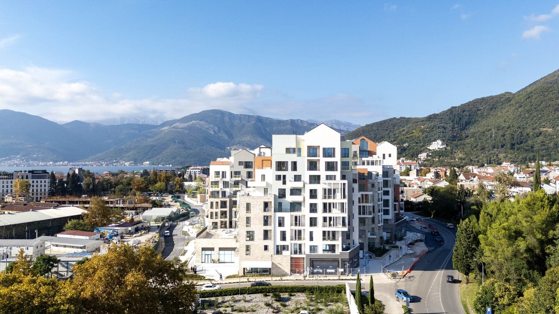 Modern residential complex in Porto Montenegro, Tivat, Montenegro: bird’s-eye view of the architecture and mountains.