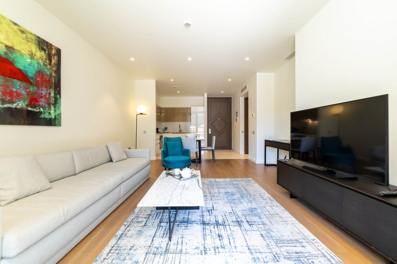 Modern living room in an apartment in Portonovi, Kumbor, Montenegro: light sofa, marble coffee table, and TV area.