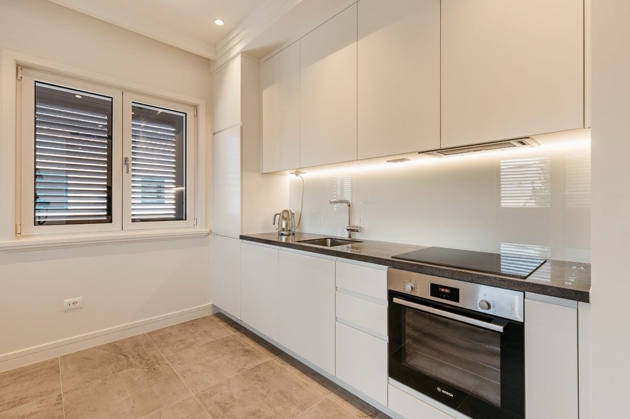 Modern white kitchen with Bosch appliances in an apartment in Luštica Bay, Radovići, Montenegro.
