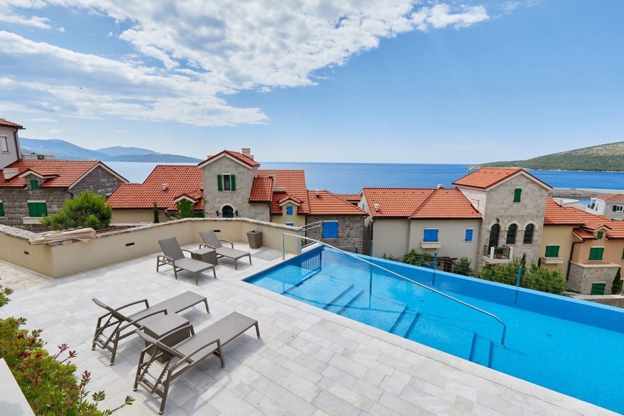 Infinity pool with sun loungers and panoramic sea views in Luštica Bay, Radovići, Montenegro.
