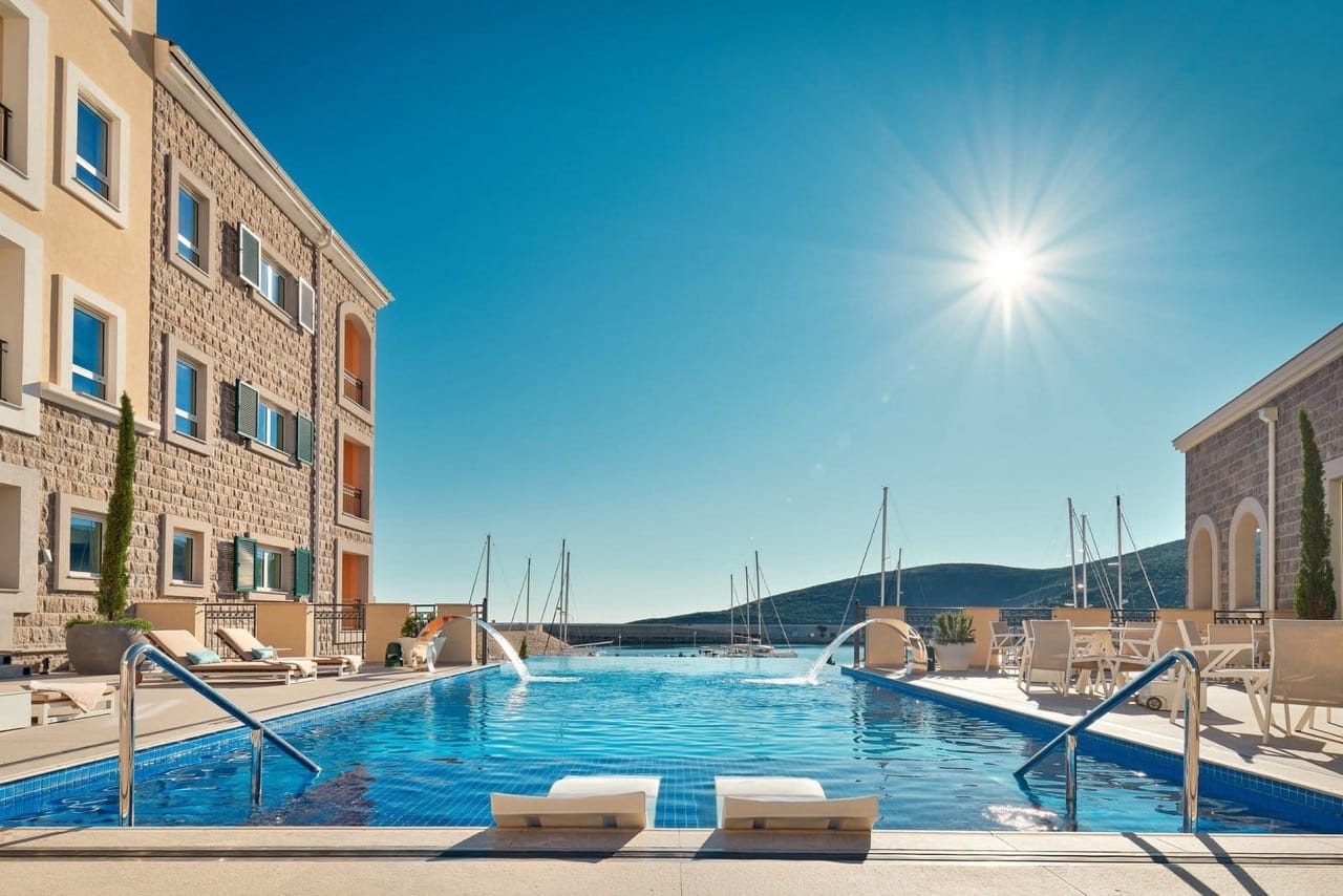 Infinity pool overlooking the marina and yachts in the upscale Luštica Bay complex, Radovići, Montenegro.