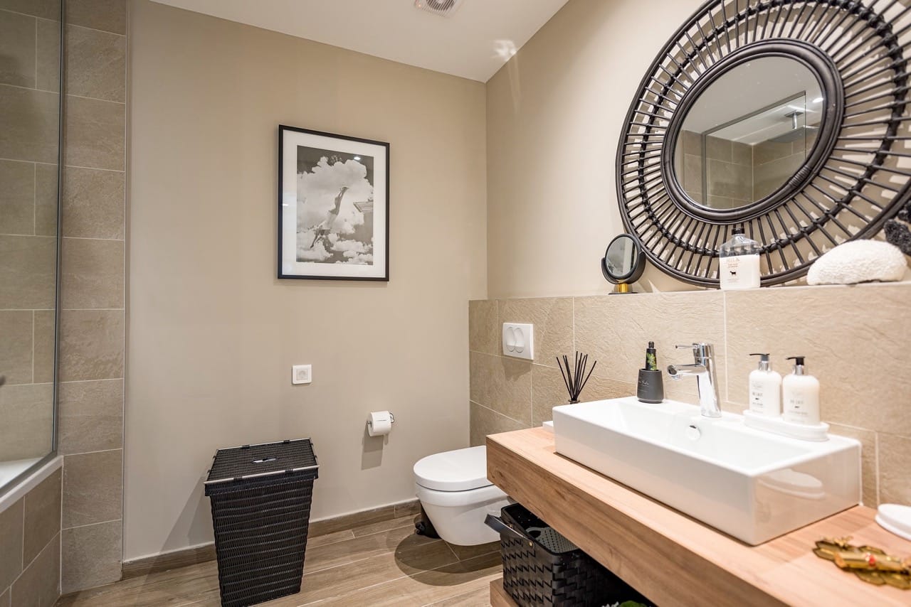 Modern bathroom in an apartment in Luštica Bay, Radovići, Montenegro: stylish fixtures and rattan decor.