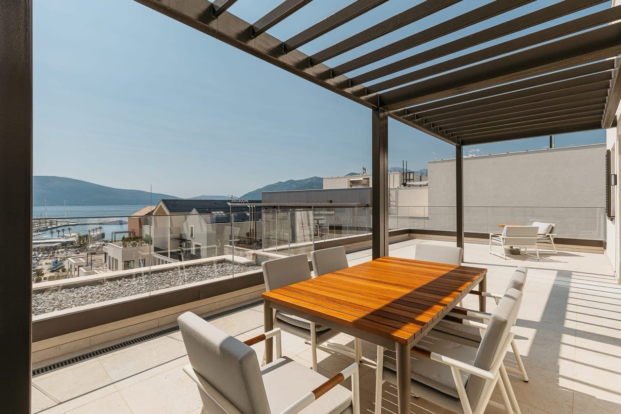 Terrace with dining area and sea view in Porto Montenegro, Tivat, Montenegro: modern furniture and pergola.