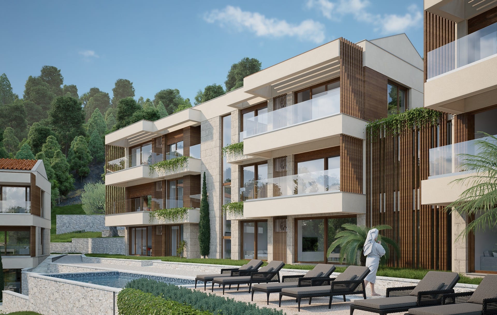 Modern residential complex with a pool and terraces in Blizikuće, Montenegro: view of the facade and relaxation area.