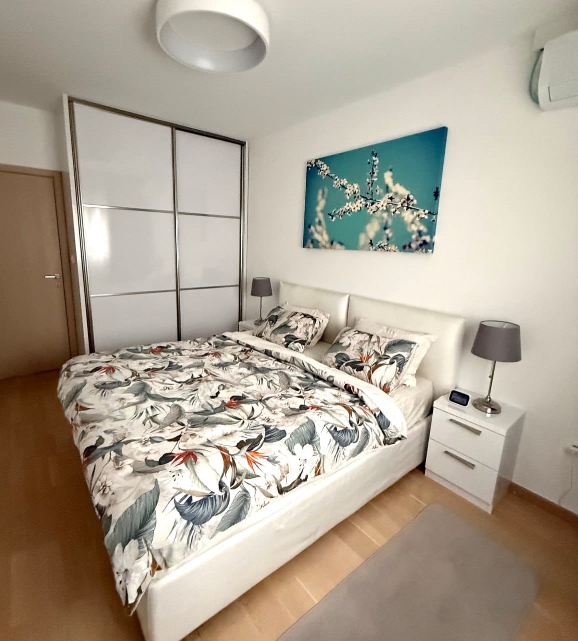 Bright bedroom in an apartment in Podgorica, Montenegro: double bed, built-in wardrobe, and modern finishes.
