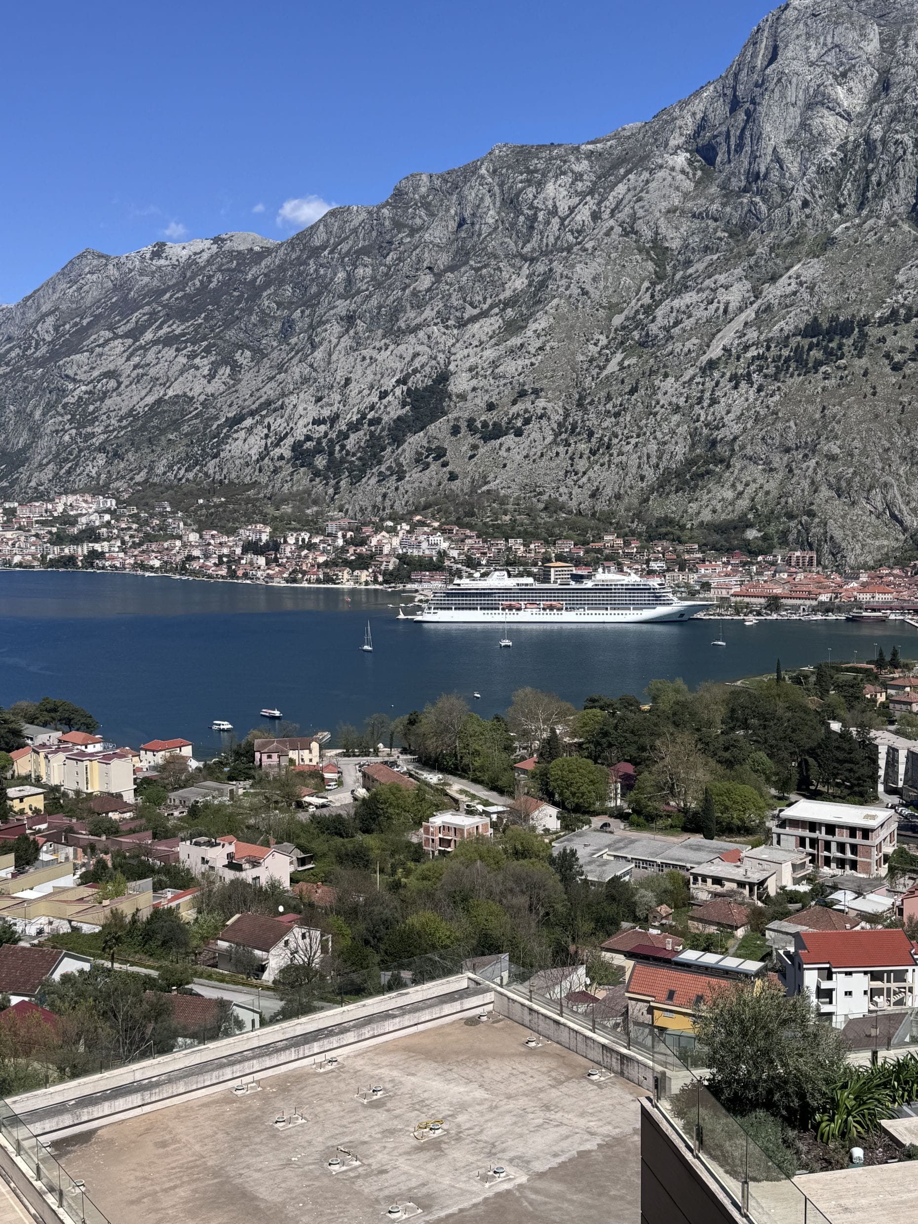 Panoramic view of the Bay of Kotor, a cruise ship, and mountains from an apartment in Kotor, Montenegro.