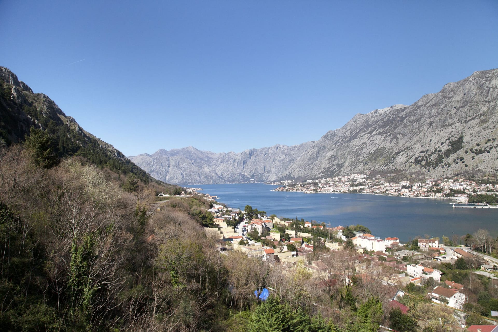 Panoramic view of the Bay of Kotor and mountains from an apartment in Kotor, Montenegro: coastal town and seascape.
