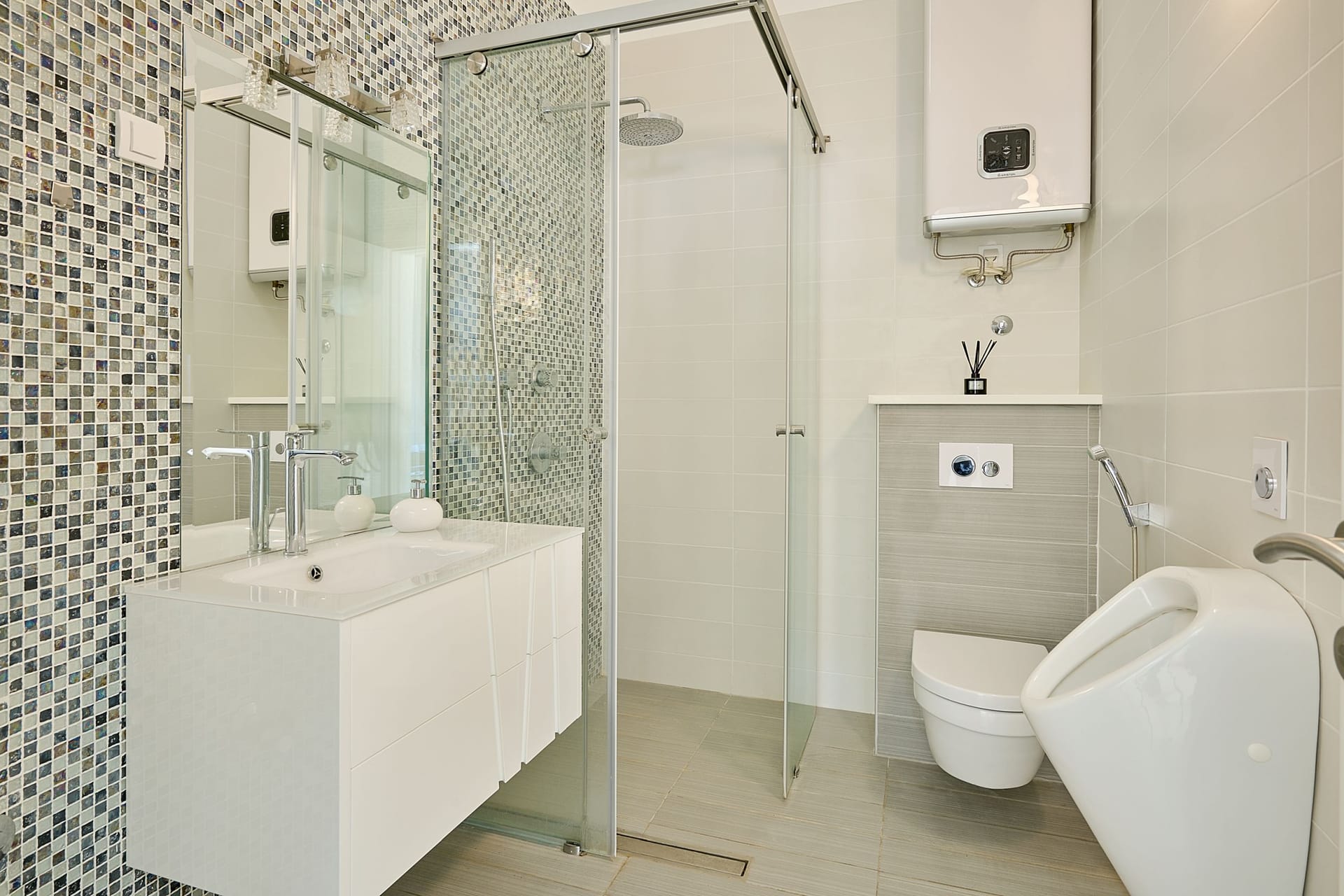 Modern bathroom with a shower cabin and mosaic in an apartment in Budva, Montenegro.