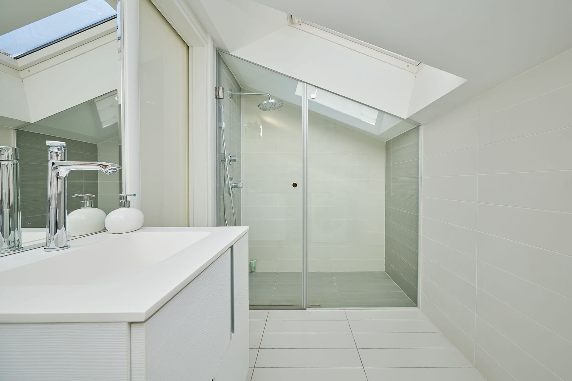 Modern bathroom with a shower cabin and a skylight in an apartment in Budva, Montenegro.