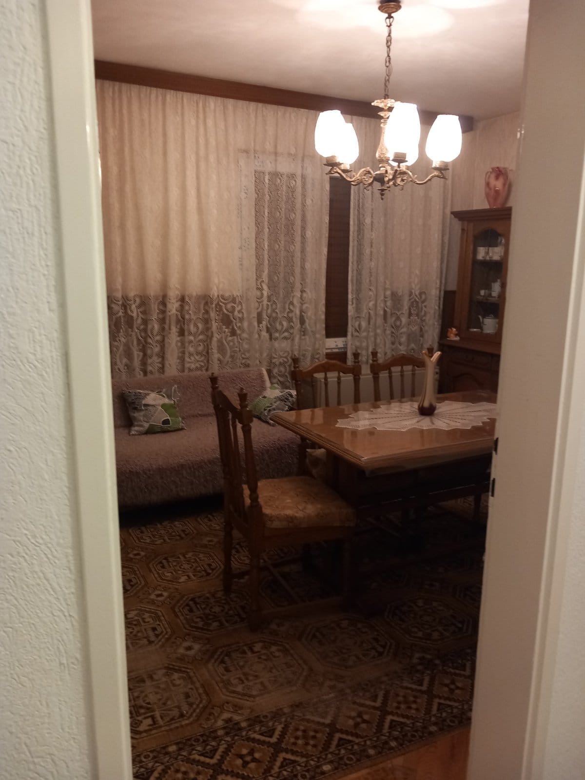 Cozy living room with dining area and classic furniture in a house for sale in Igalo, Montenegro.