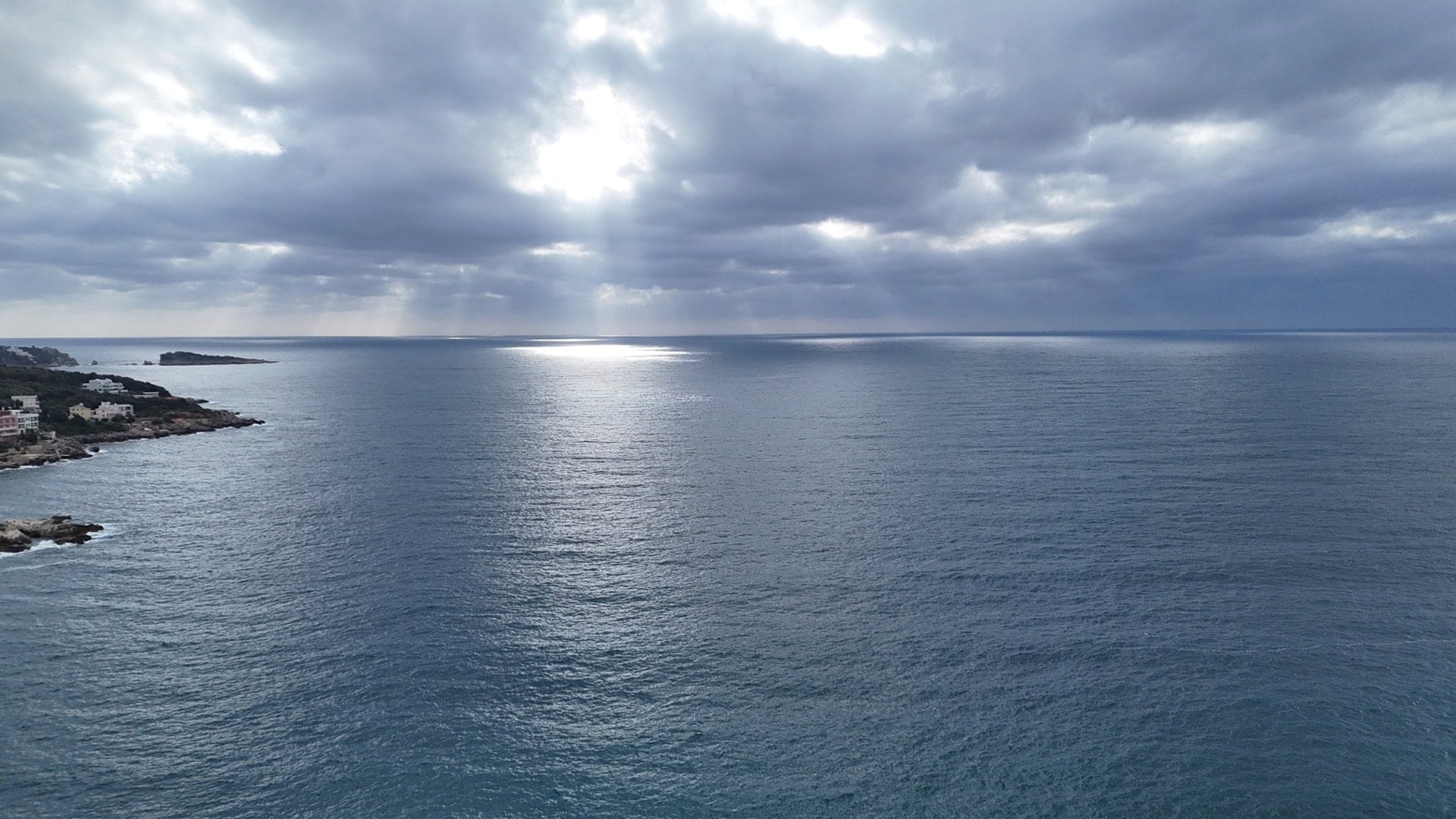 Panoramic view of the Adriatic Sea from a plot of land in the village of Utjeha, Montenegro, with a cloudy sky.