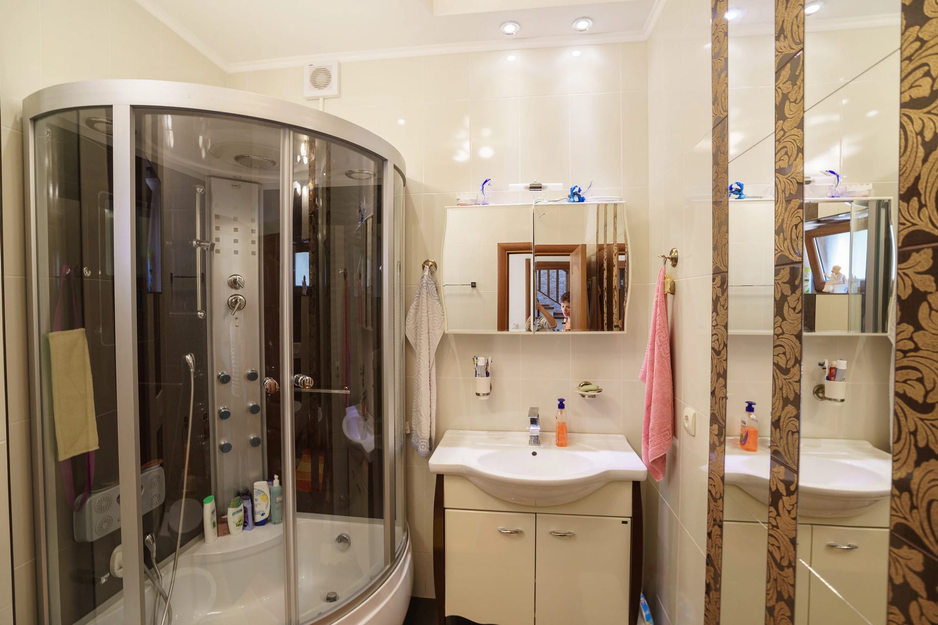 Bathroom with shower cabin and mirror in a house, Sutomore, Montenegro. Light tiles and modern plumbing.