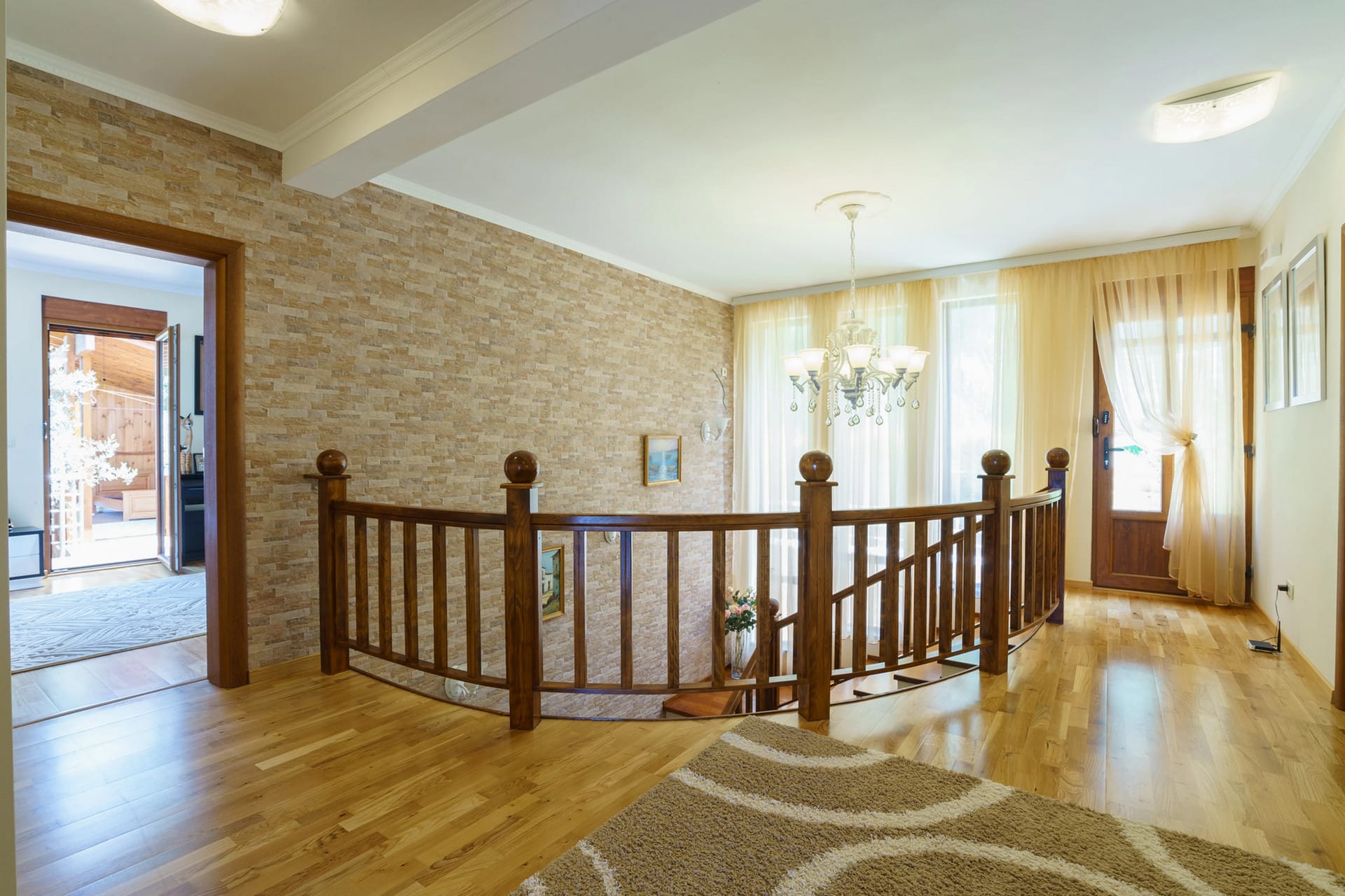 Living room interior with a wooden staircase and stone wall finishes in a house, Sutomore, Montenegro