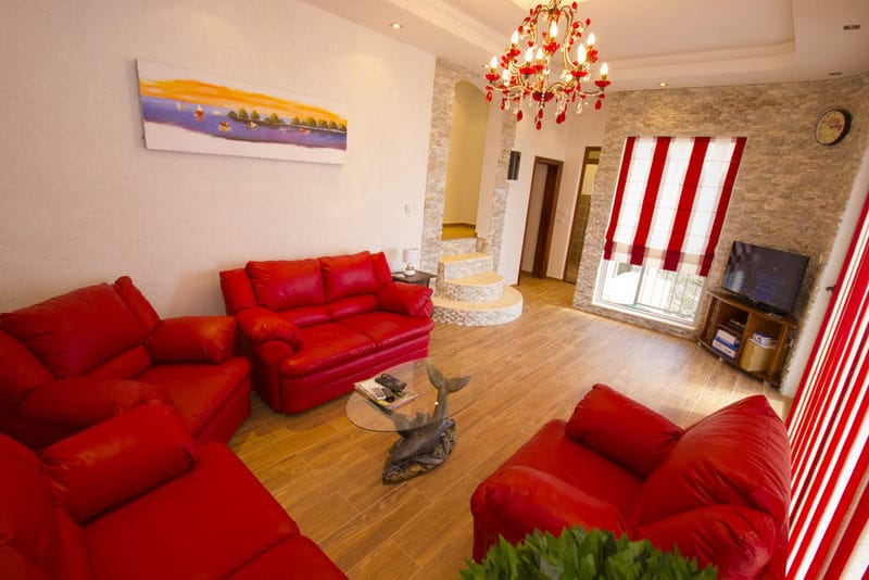 Living room with red leather sofas and stone finishes in a house, Dobri Vody, Montenegro.