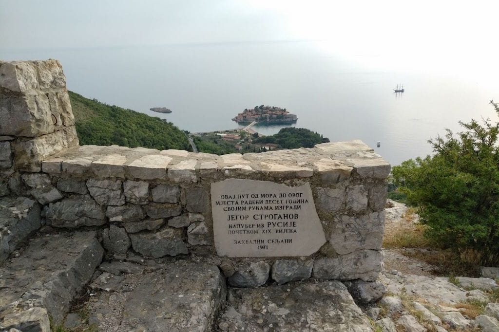 Panoramic view of Sveti Stefan Island and the Adriatic Sea from a historic stone viewpoint, Montenegro.