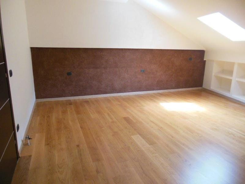 Bright attic bedroom with parquet flooring and decorative wall finishes in an apartment, Rafailovichi, Montenegro.