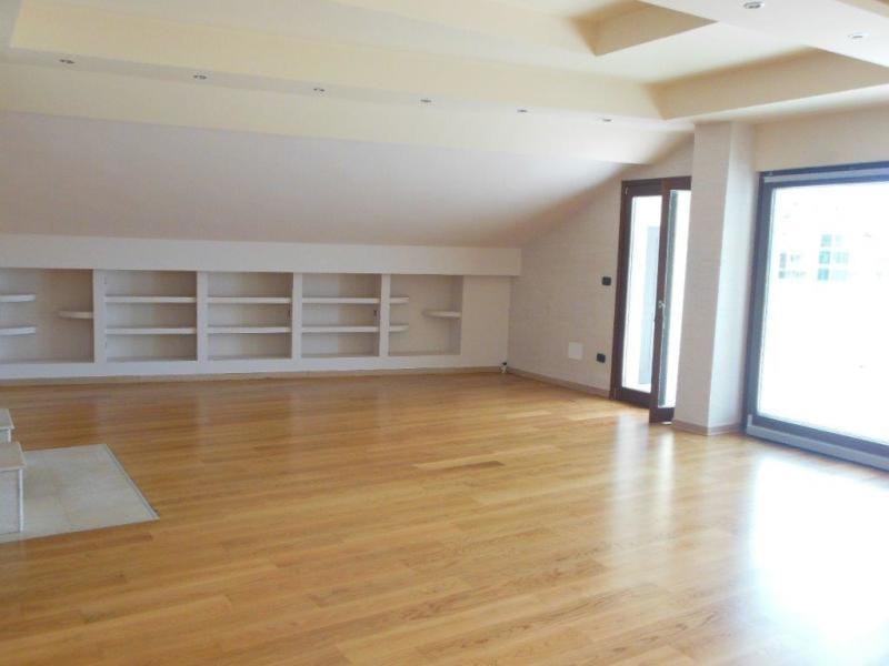 Spacious attic living room with parquet flooring and built-in shelves in an apartment, Rafailovići, Montenegro.