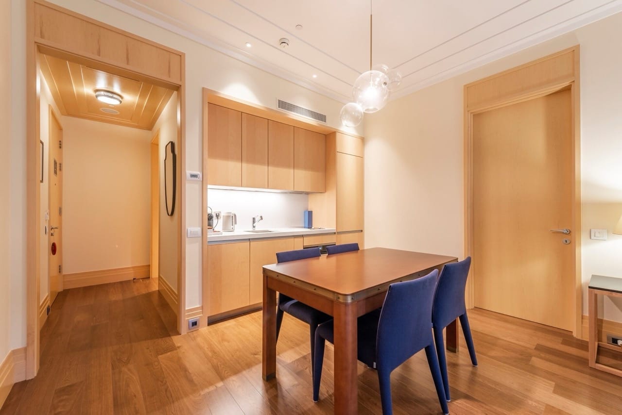 Modern kitchen with wooden furniture and dining area in an apartment in Porto Montenegro, Tivat, Montenegro.