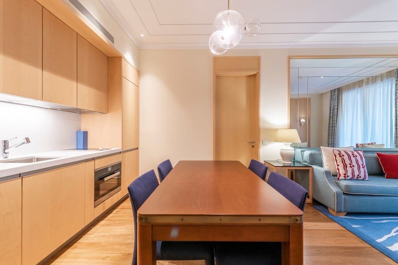 Modern kitchen-living room with wooden furniture in an apartment in Porto Montenegro, Tivat, Montenegro.