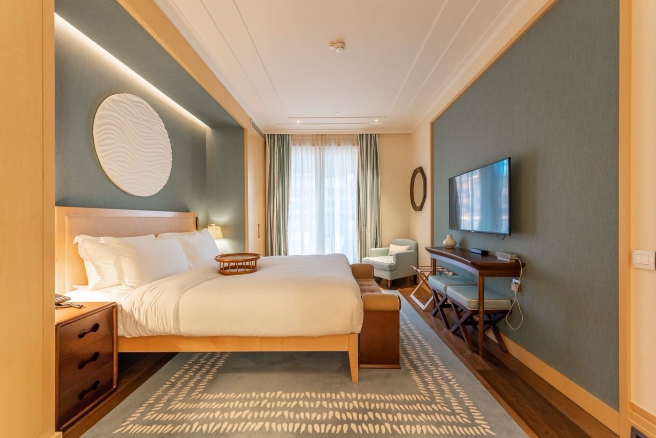Modern bedroom in an apartment in Porto Montenegro, Tivat, Montenegro: double bed, TV, and stylish interior.