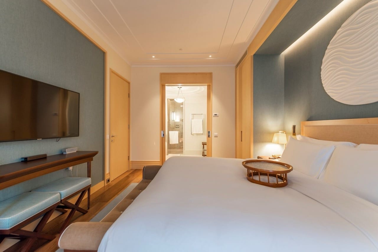 Modern bedroom in Porto Montenegro apartments, Tivat, Montenegro: double bed, TV, and bathroom.