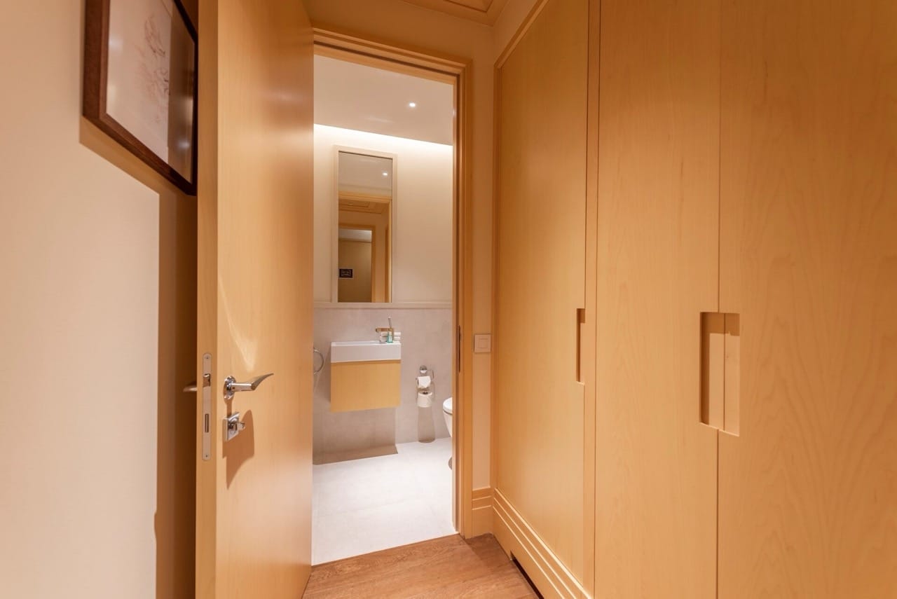 Modern bathroom with light wood finishes in an apartment in Porto Montenegro, Tivat, Montenegro.