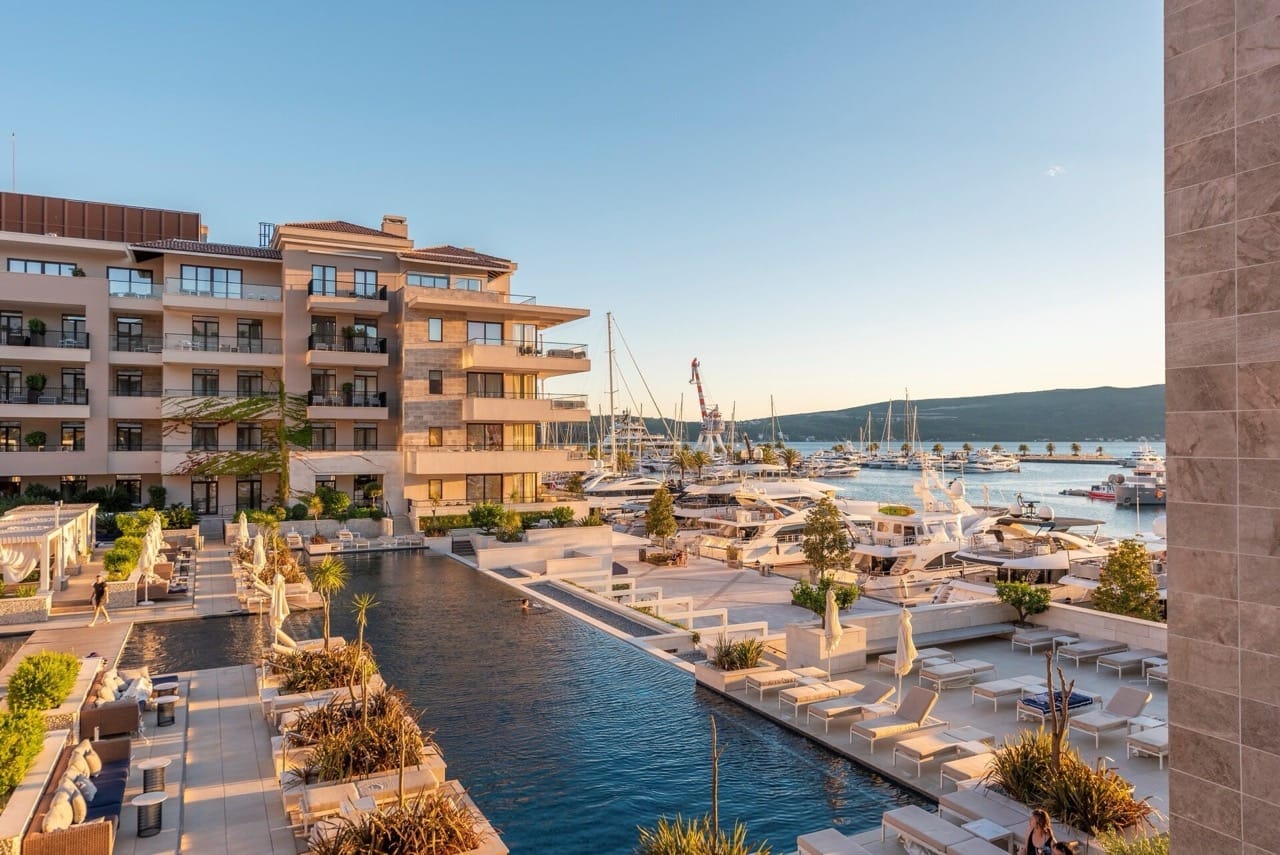 View of the pool and Porto Montenegro yacht marina in Tivat, Montenegro: a modern residential complex with terraces.