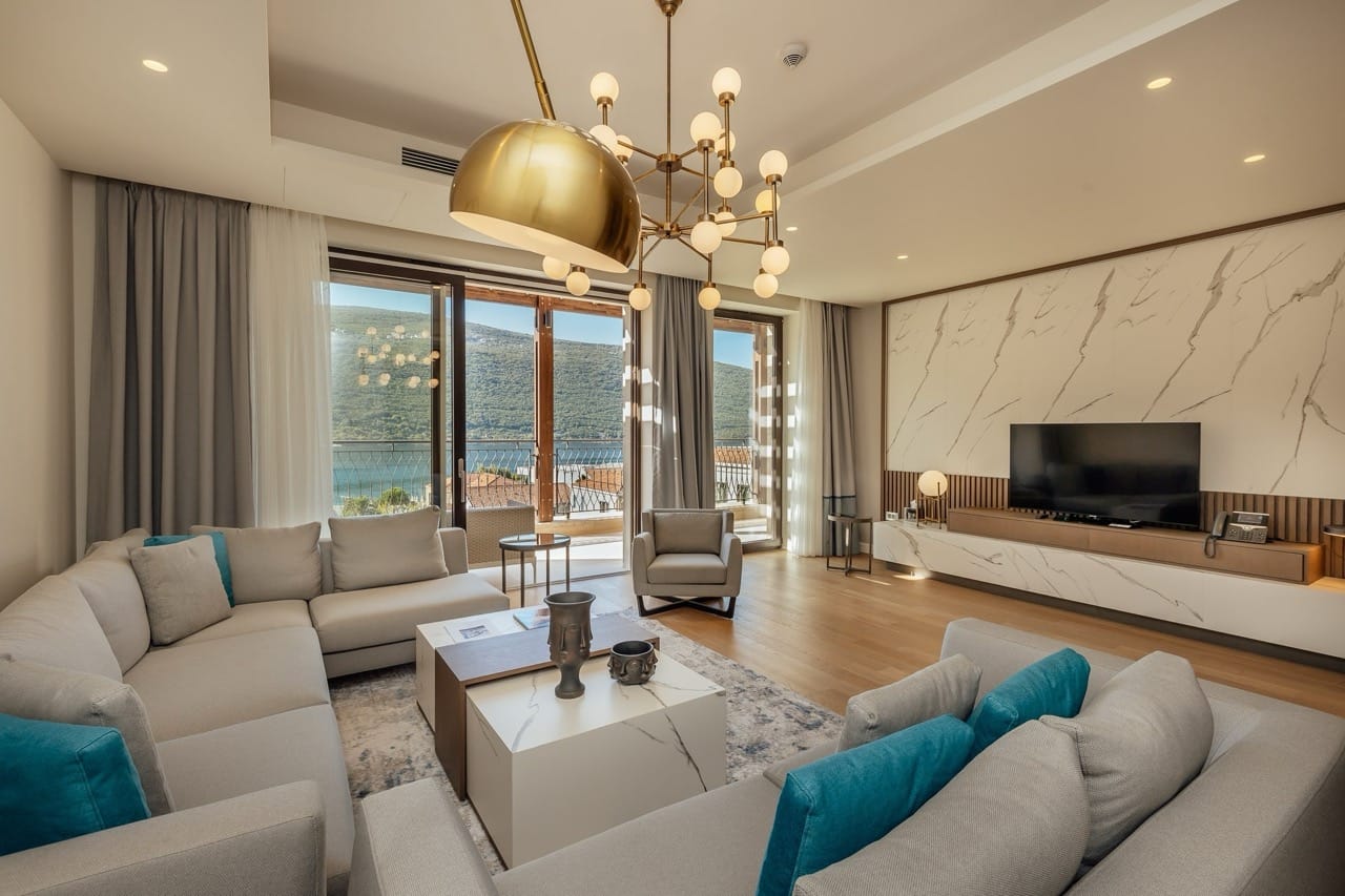 Modern living room in Portonovi, Kumbor, Montenegro: light furniture, marble finishes, and sea view from the terrace.