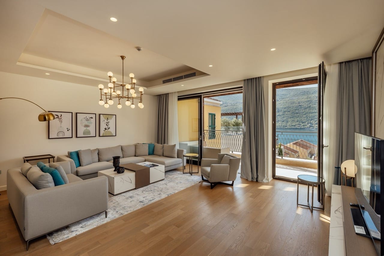 Modern living room in Portonovi, Kumbor, Montenegro: stylish furniture, marble table, and sea view from the terrace.