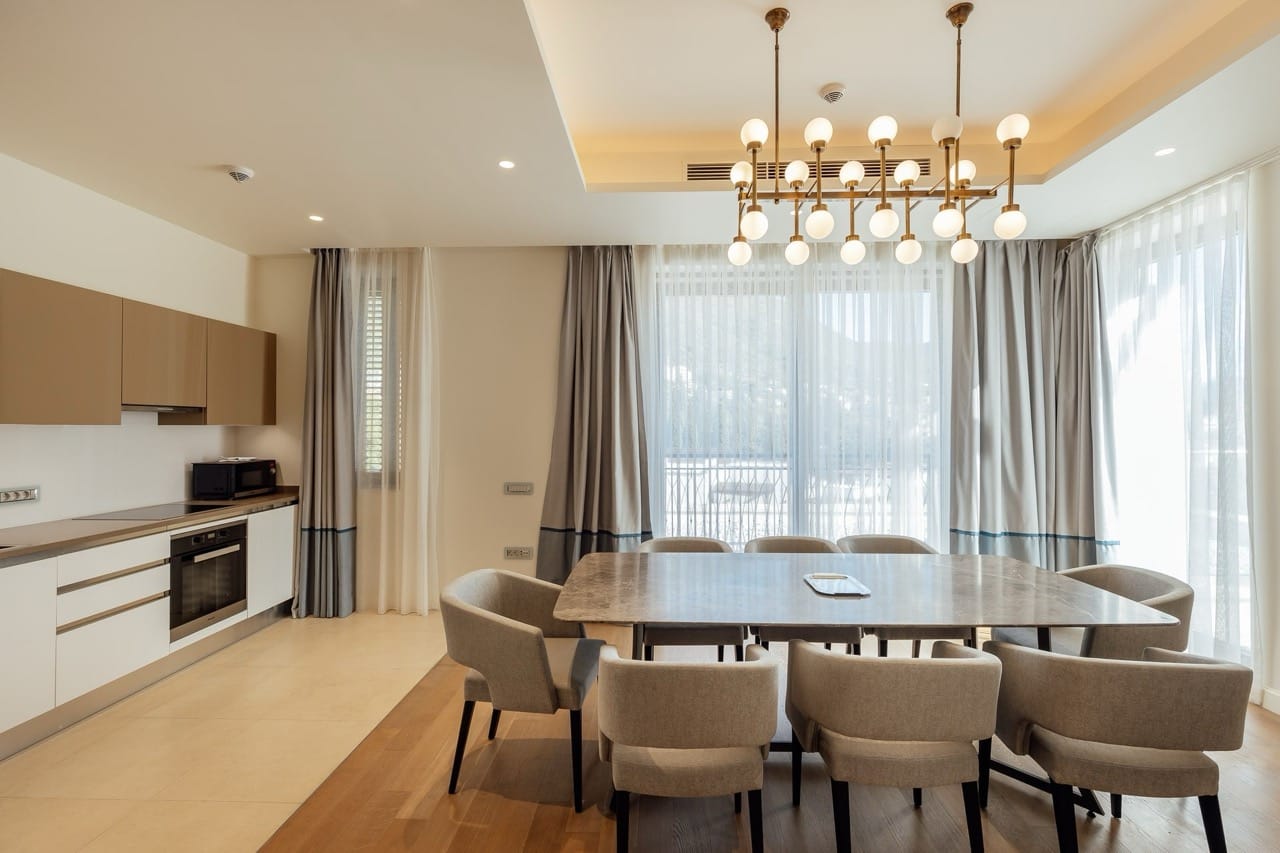 Modern kitchen-dining room with a marble table in a luxury apartment in Portonovi, Kumbor, Montenegro.