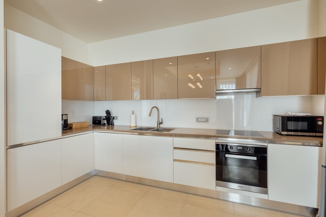 Modern kitchen with glossy fronts and Miele appliances in an apartment in Portonovi, Kumbor, Montenegro.