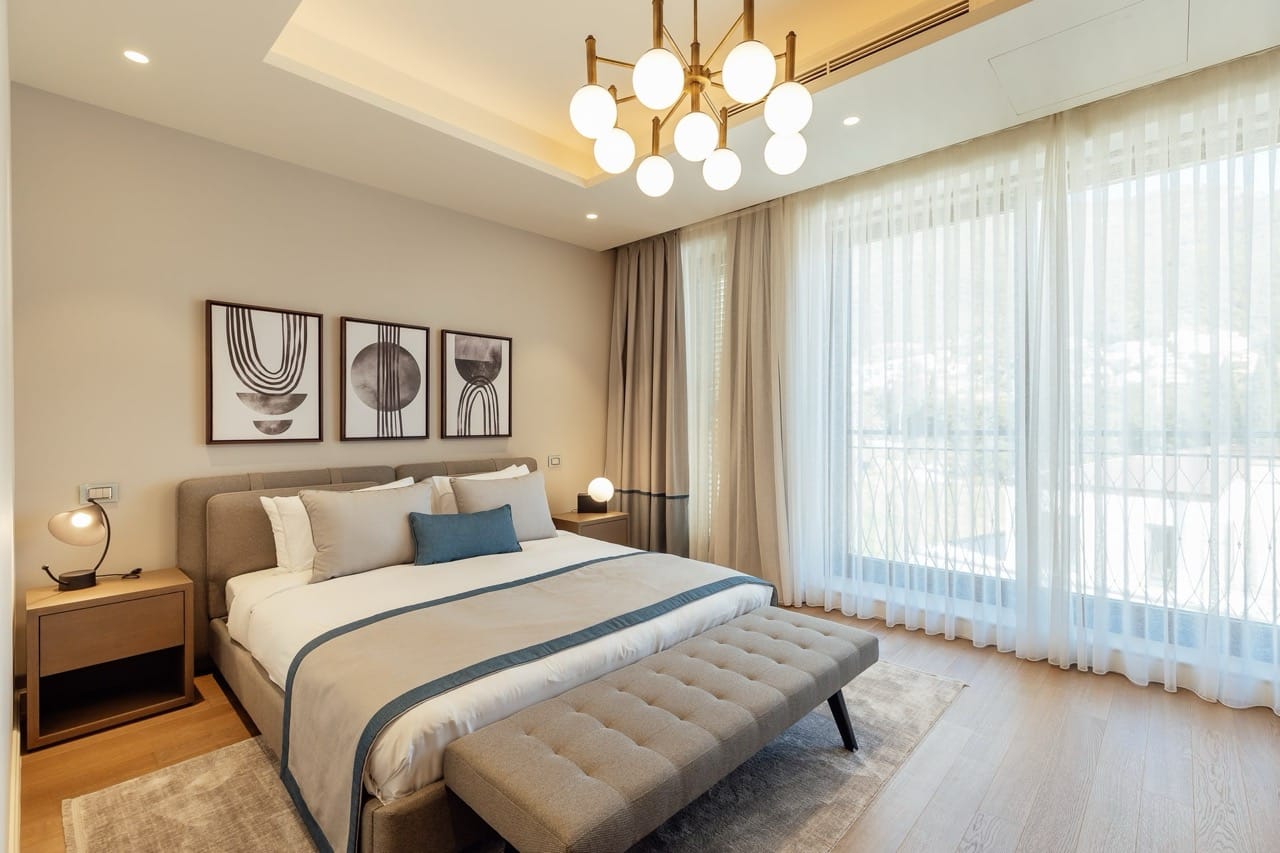 Modern bedroom with a double bed in an apartment in Portonovi, Kumbor, Montenegro: stylish interior and panoramic windows.