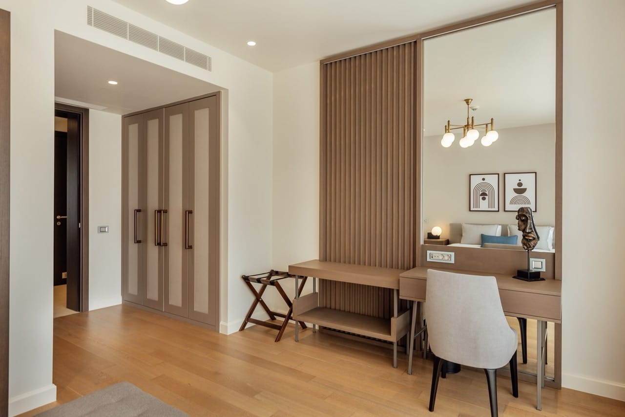 Modern bedroom in Portonovi, Kumbor, Montenegro: built-in wardrobe, vanity table, and stylish interior.
