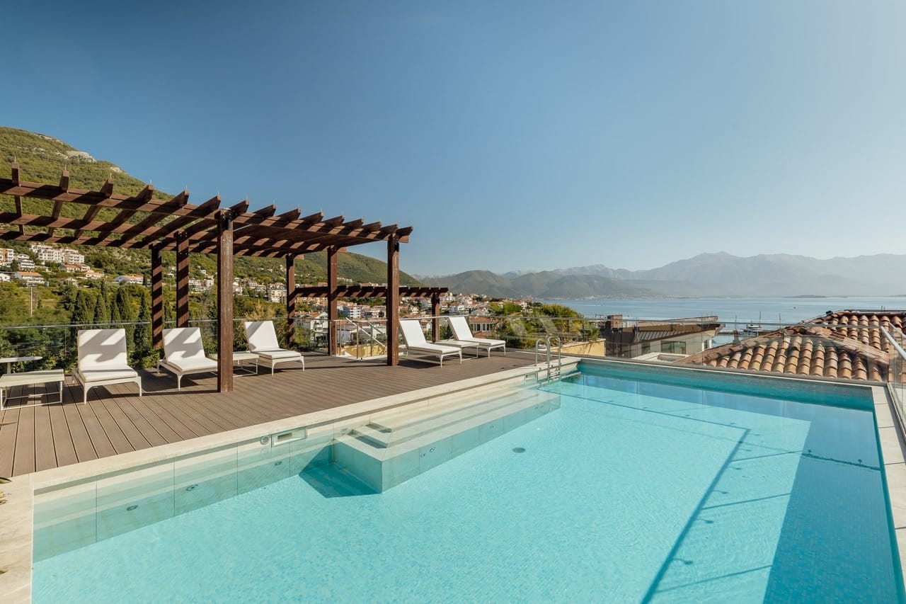 Pool on the terrace with sun loungers and sea view in Portonovi, Kumbor, Montenegro. Wooden pergola and panorama.