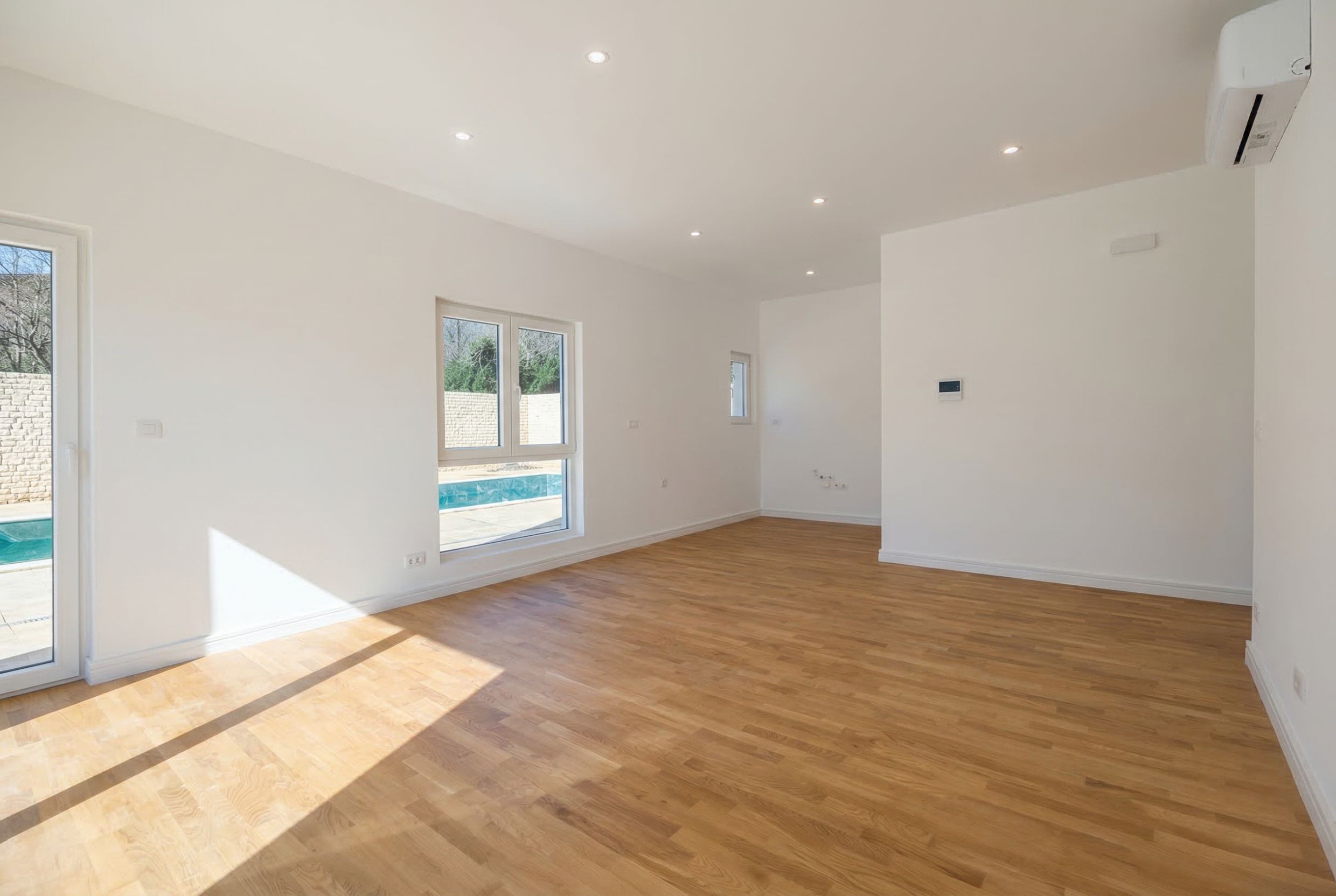 Bright living room with parquet flooring and access to the pool in an apartment, Sutomore, Montenegro.